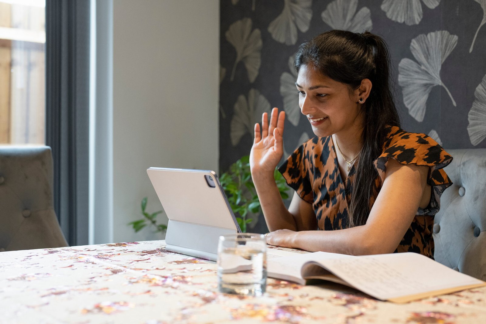 Woman working on tablet from home