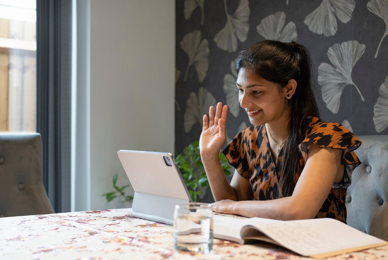 Woman working on tablet from home