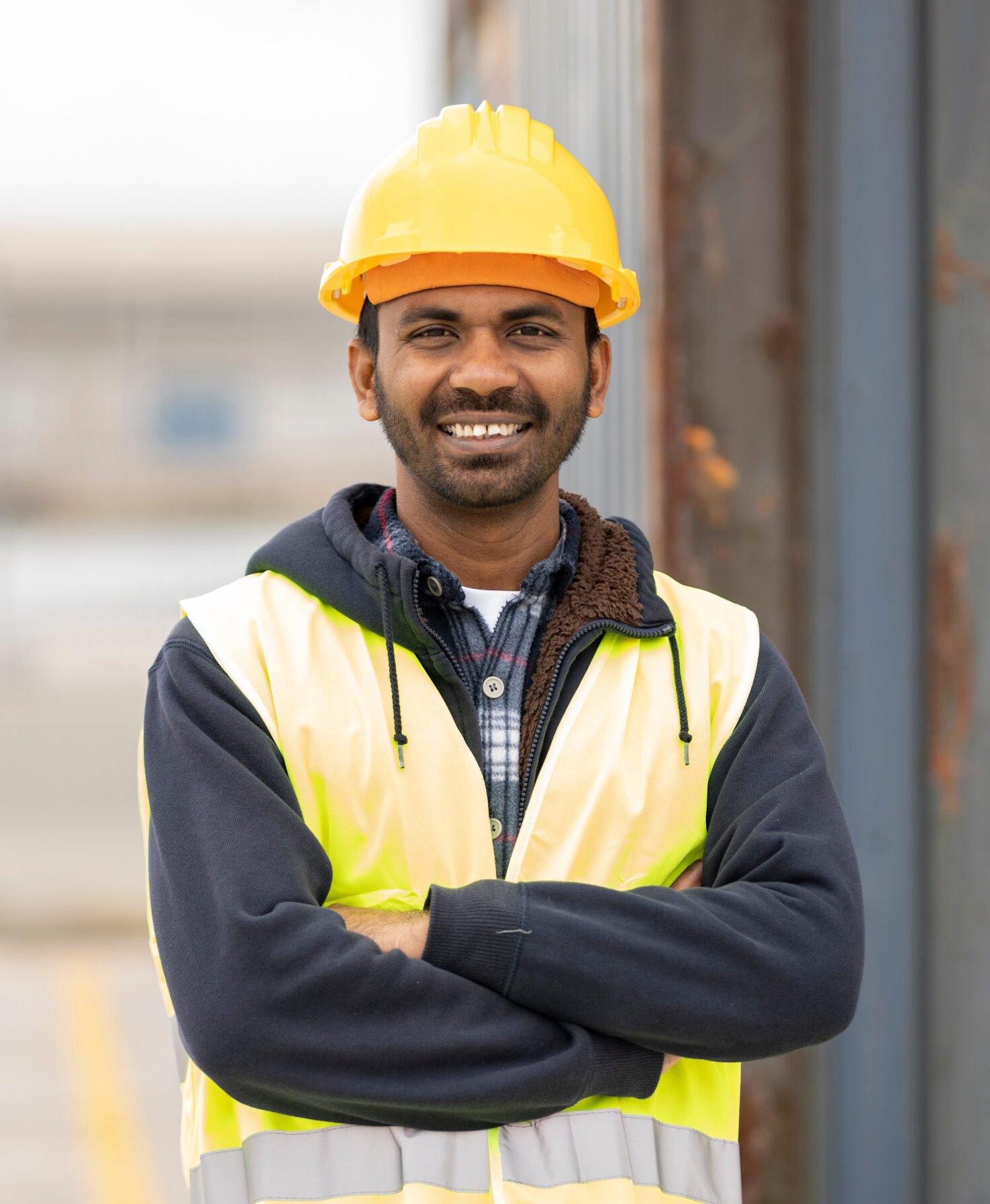 indian engineer man working in logistics at container port - migrant worker man concept -